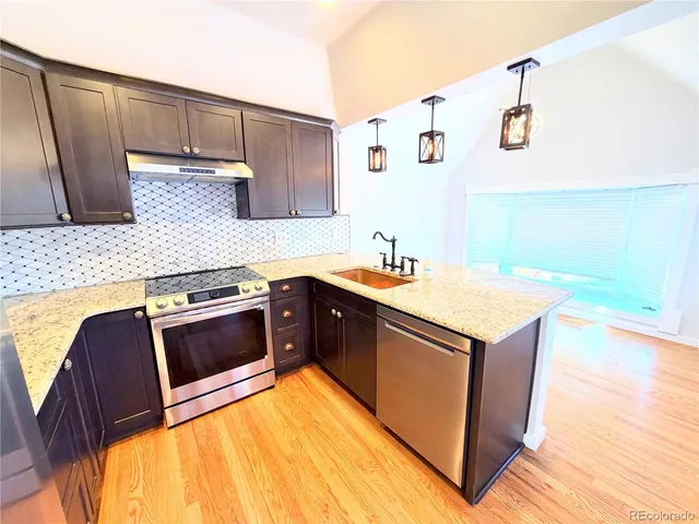 a view of an empty room and wooden floor