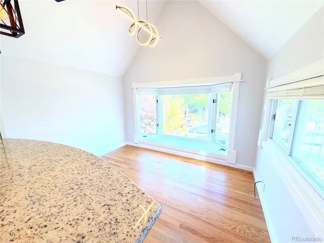 a kitchen view of a stove and a wooden floor
