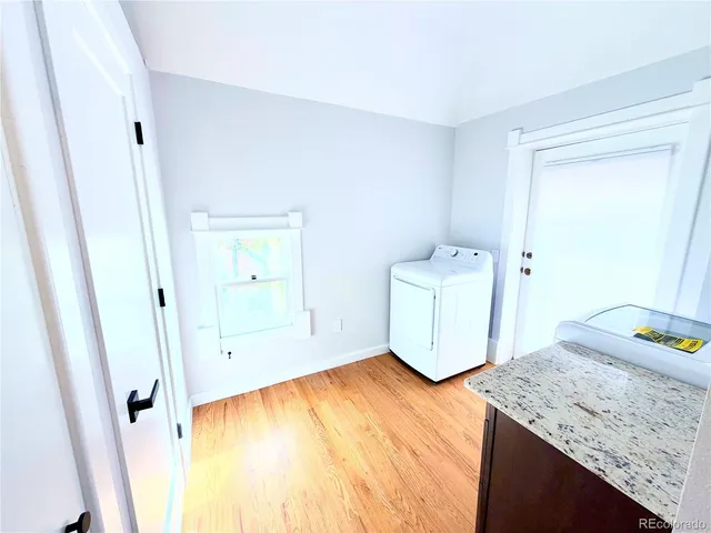 a view of a room with wooden floor and bedroom