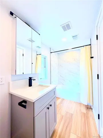 a view of a house with a wooden fence