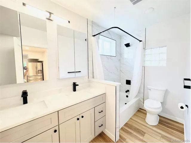 an empty room with wooden floor and a window