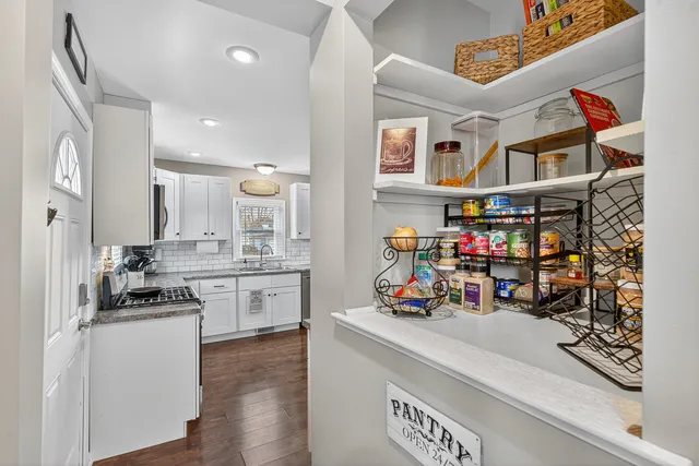 a kitchen with stainless steel appliances granite countertop a sink dishwasher and cabinets with wooden floor