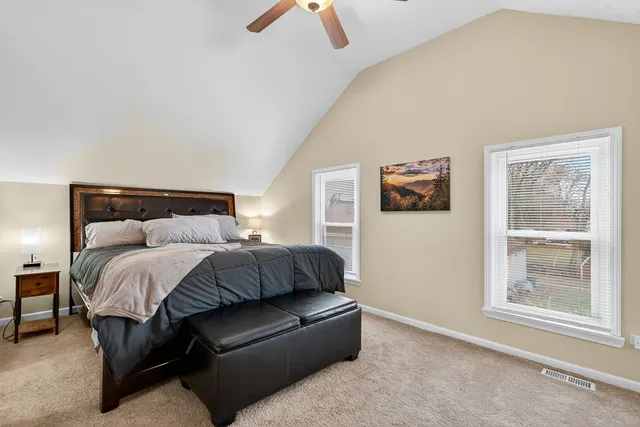 a bedroom with a bed and a window