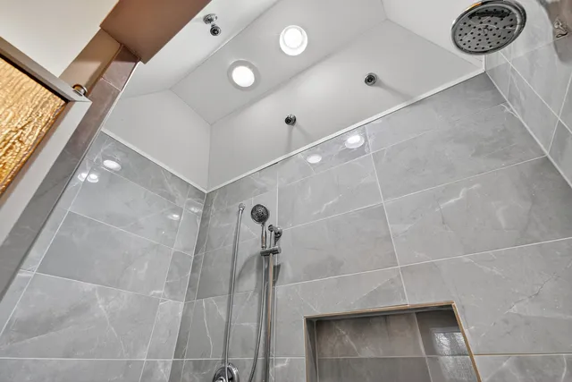 a bathroom with a shower and a sink