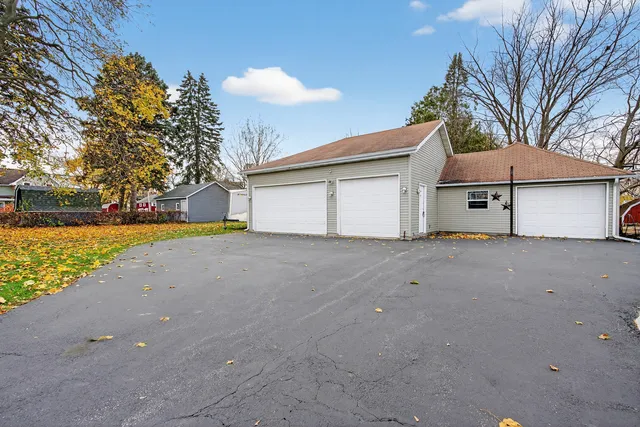 a view of a house with a yard and garage