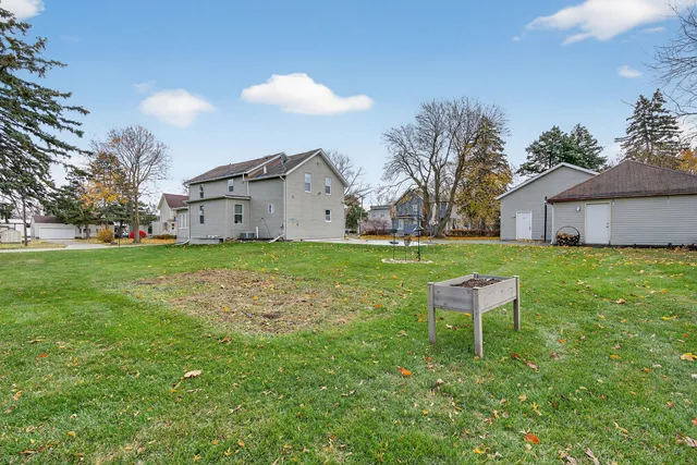 a view of a house with a yard and sitting area