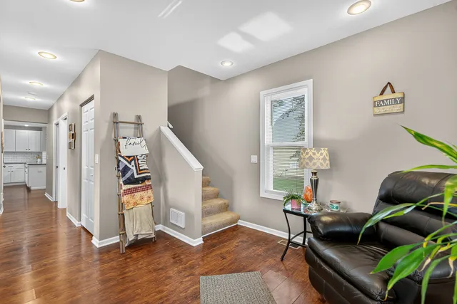 a living room with furniture and wooden floor