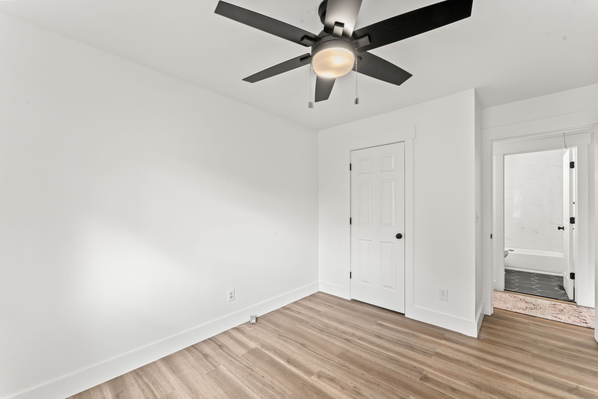 841 Neelys Bend Road Madison, TN 37115 - Photo 12 of 17 an empty room with wooden floor a ceiling fan and fan