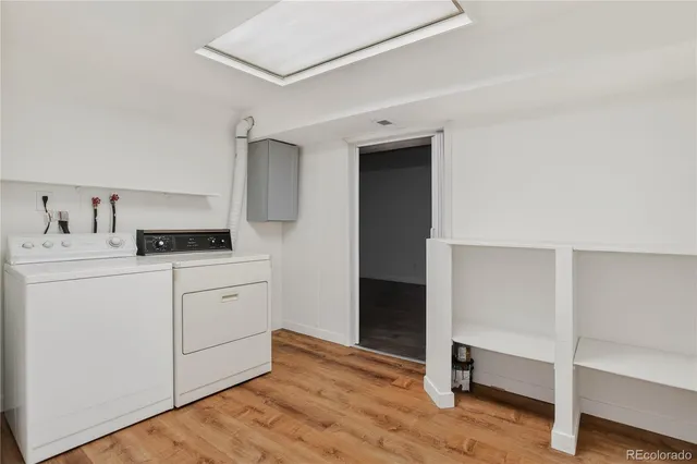 a kitchen with a refrigerator and white cabinets
