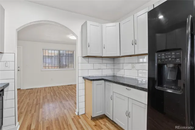 a kitchen with a sink and refrigerator