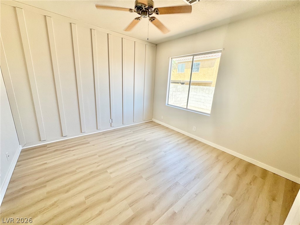 7340 Ridge Star Court Las Vegas, NV 89131 - Photo 16 of 22 Board and batten accent wall enhances this inviting room with light wood-style flooring.