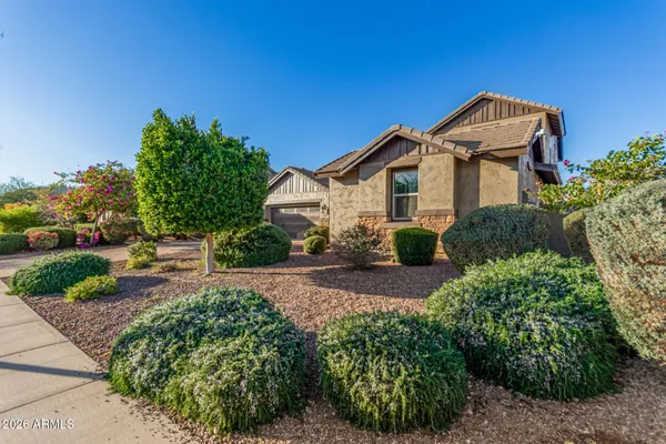 a view of a house with a small yard and plants