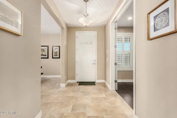 a living room with furniture kitchen view and a chandelier