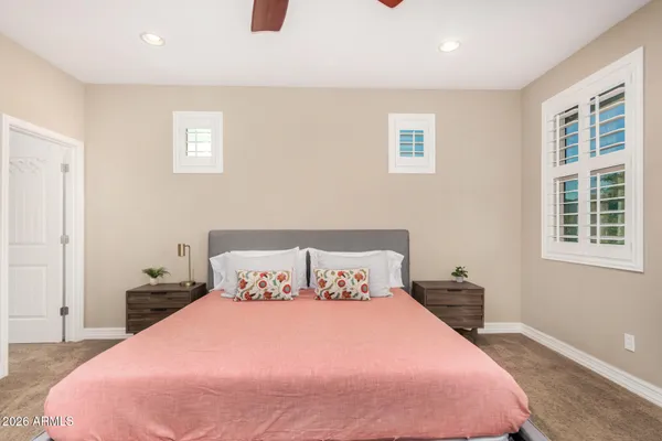 a bedroom with a bed and a painting on the wall