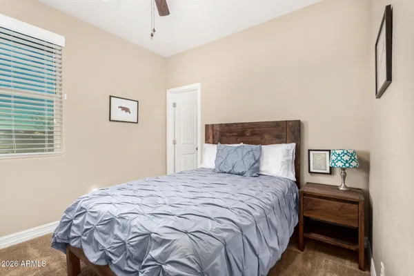 a spacious bedroom with a bed and a chandelier