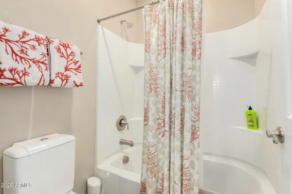 a bedroom with a bed and a mirror