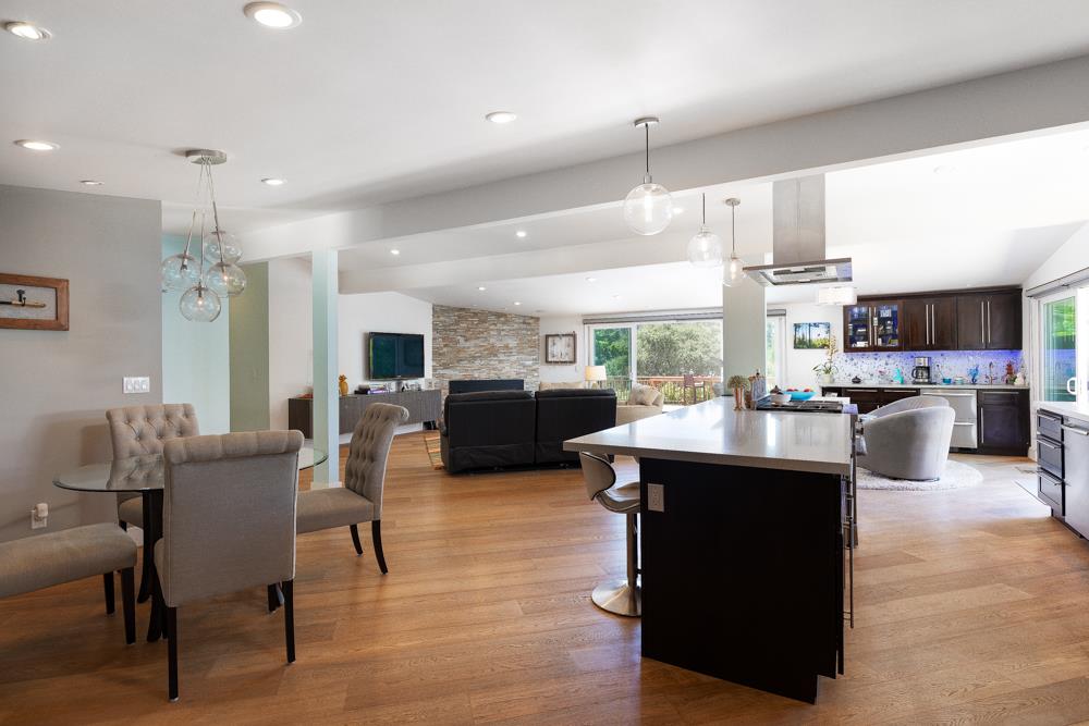 377 Brooktree Ranch Road Aptos, CA 95003 - Photo 14 of 50 a dining hall with stainless steel appliances kitchen island granite countertop a table chairs and a living room view