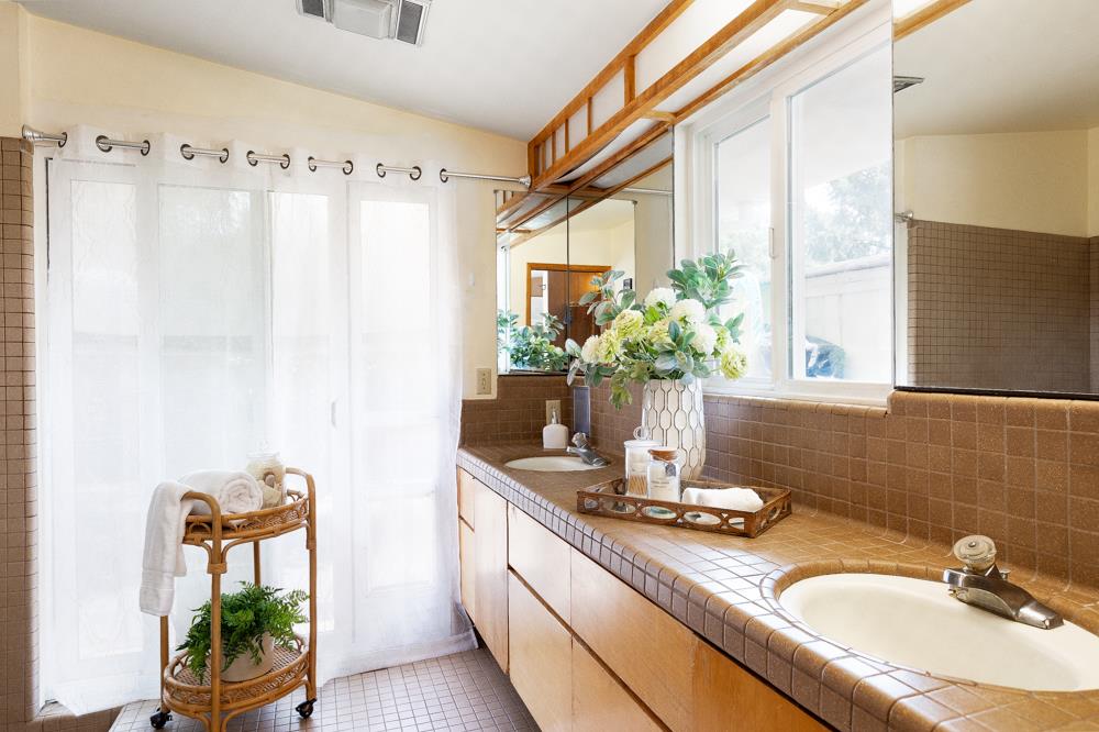 377 Brooktree Ranch Road Aptos, CA 95003 - Photo 22 of 50 a bathroom with a granite countertop sink a mirror and a shower