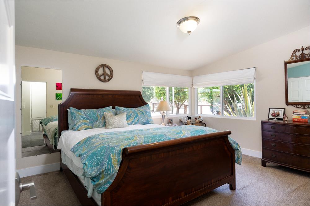 377 Brooktree Ranch Road Aptos, CA 95003 - Photo 25 of 50 a bedroom with a bed and a dresser next to a window