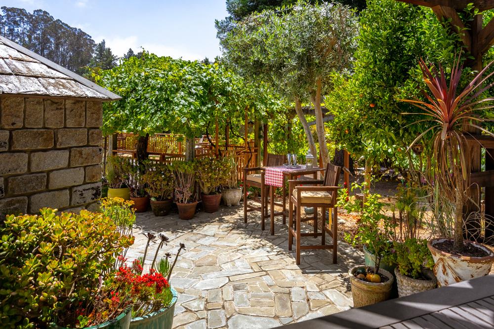 377 Brooktree Ranch Road Aptos, CA 95003 - Photo 32 of 50 a view of a patio with table and chairs and potted plants