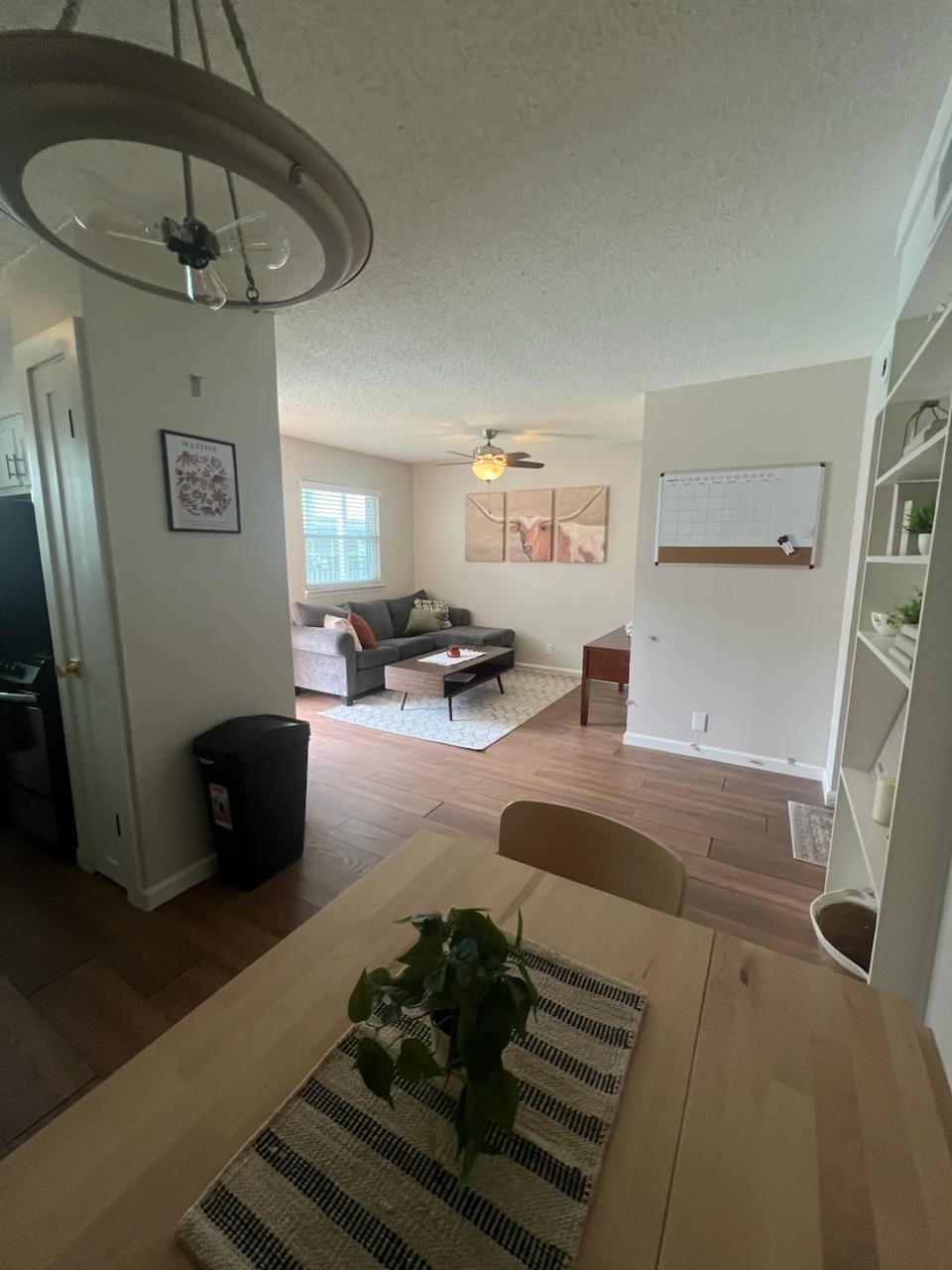 2401 Manor St Road, Unit 118 Austin, TX 78722 - Photo 9 of 17 a living room with furniture and a chandelier