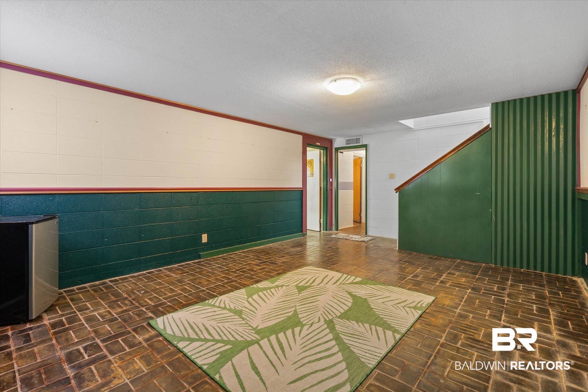 706 Sutherland Drive Chickasaw, AL 36611 - Photo 22 of 33 Interior space with brick floor, visible vents, a textured ceiling, and concrete block wall