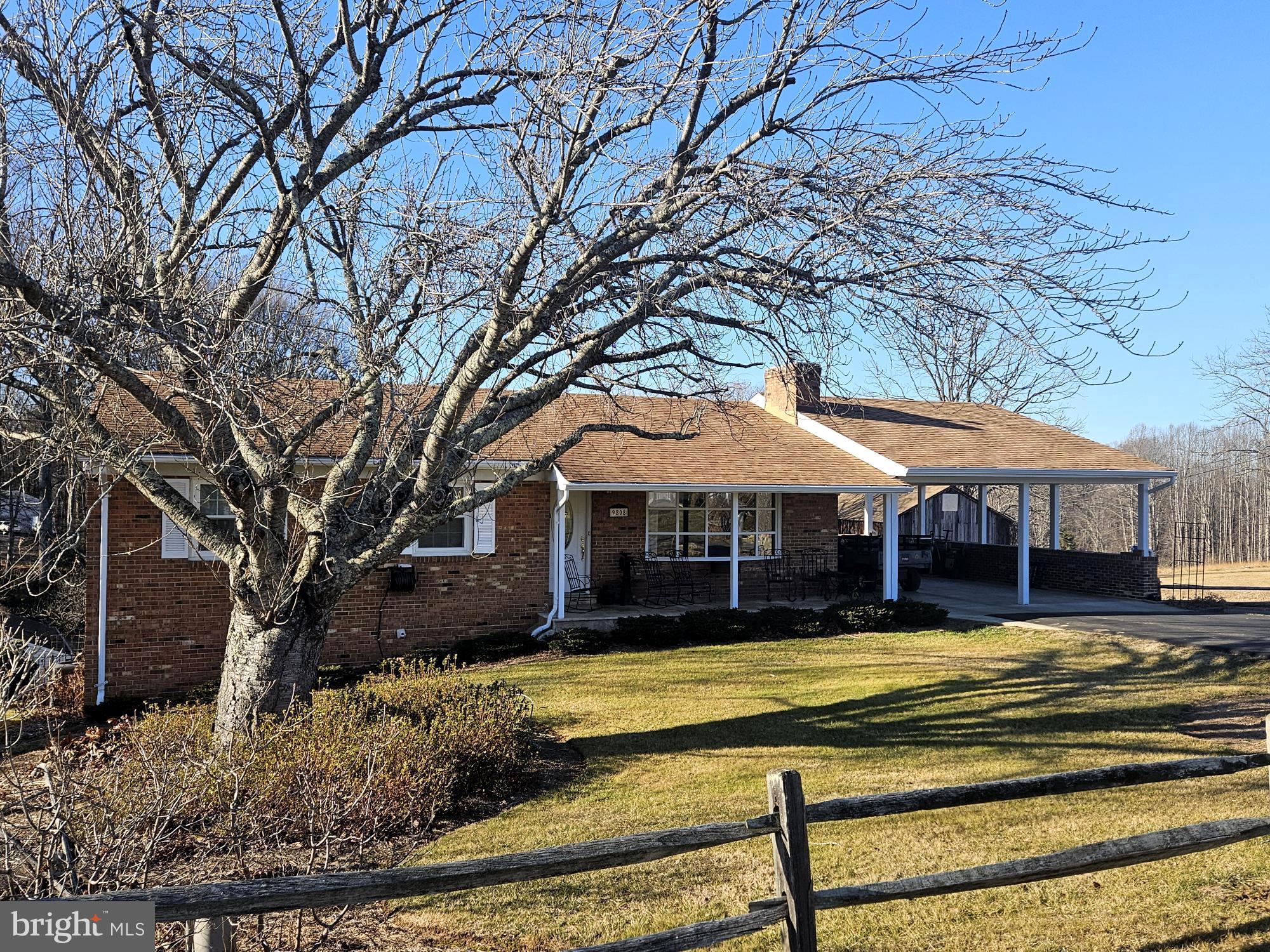 9808 Evans Ford Road Manassas, VA 20111 - Photo 2 of 3 a view of a white house with a large tree