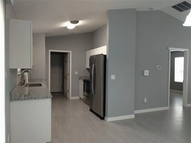 a kitchen with a refrigerator and a sink