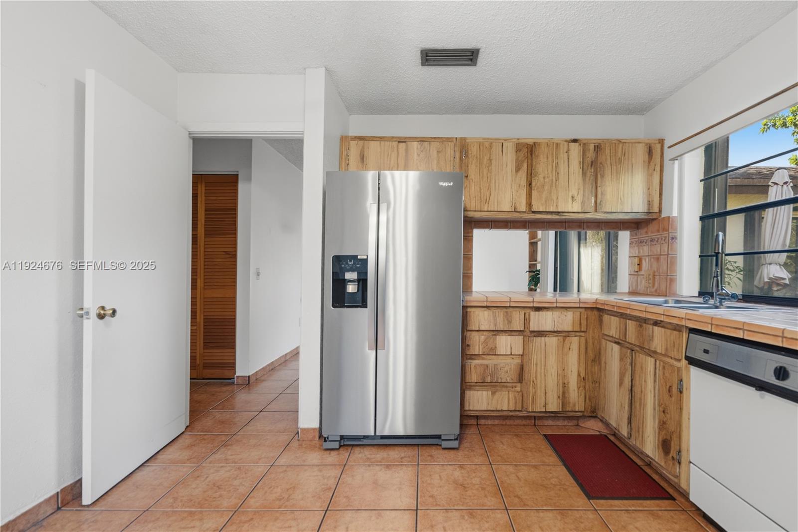13585 Southwest 114th Terrace Miami, FL 33186 - Photo 14 of 42 a kitchen with stainless steel appliances granite countertop a refrigerator and a sink