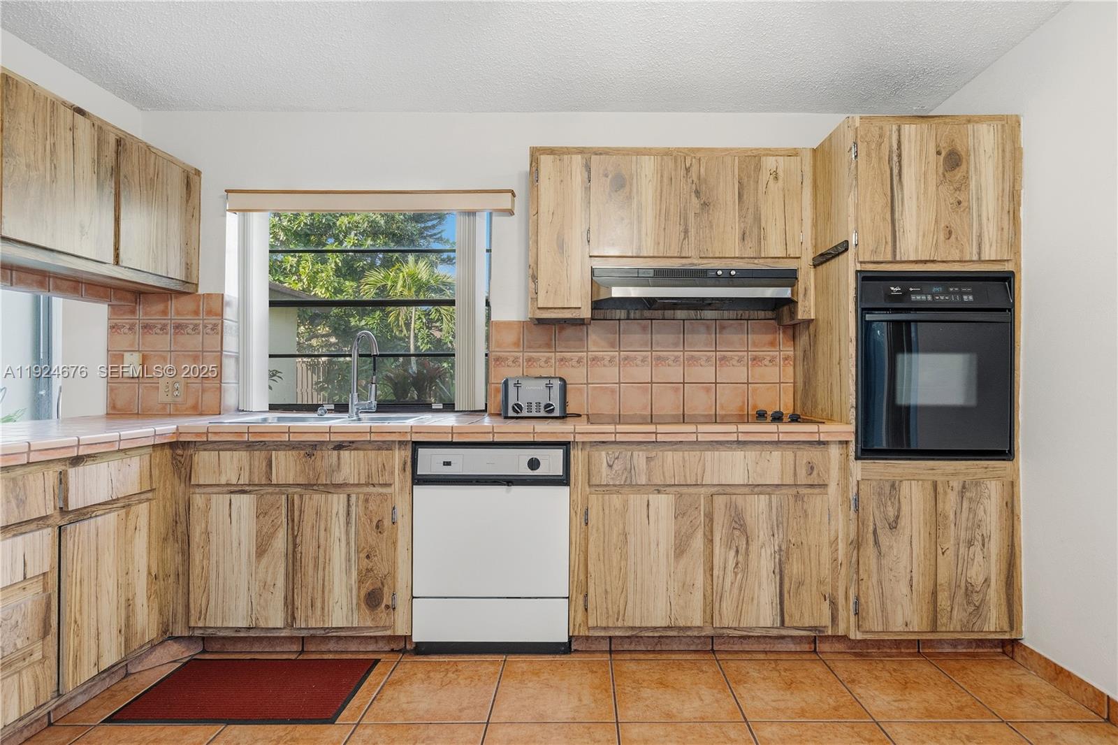 13585 Southwest 114th Terrace Miami, FL 33186 - Photo 15 of 42 a kitchen with granite countertop white cabinets and window