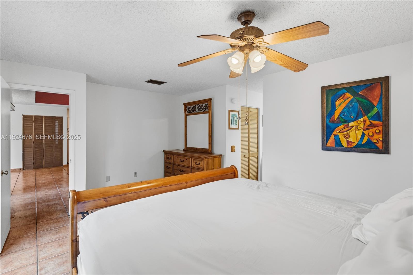 13585 Southwest 114th Terrace Miami, FL 33186 - Photo 17 of 42 a bedroom with a bed and a chandelier