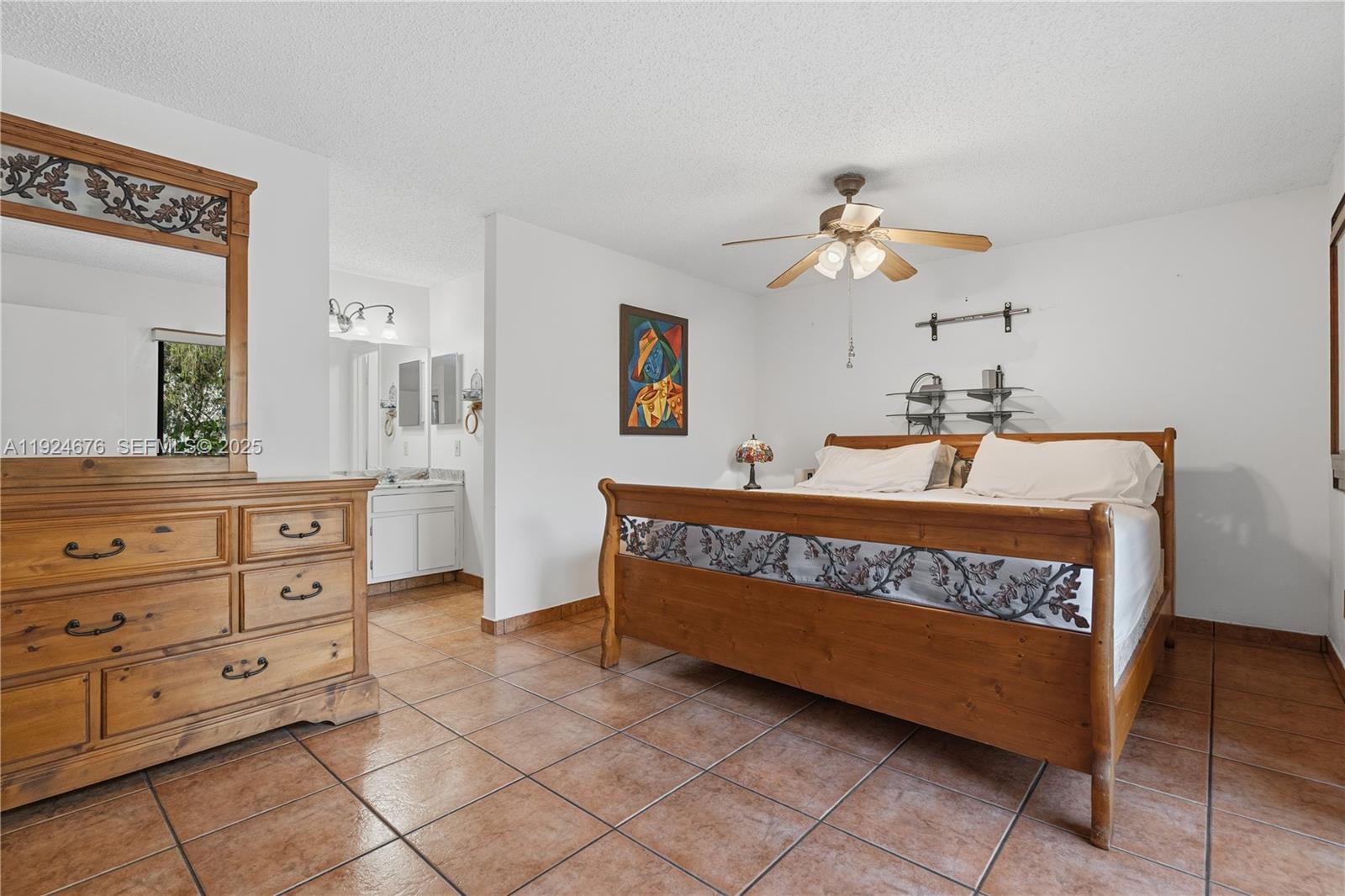 13585 Southwest 114th Terrace Miami, FL 33186 - Photo 18 of 42 a bedroom with a bed and a dresser