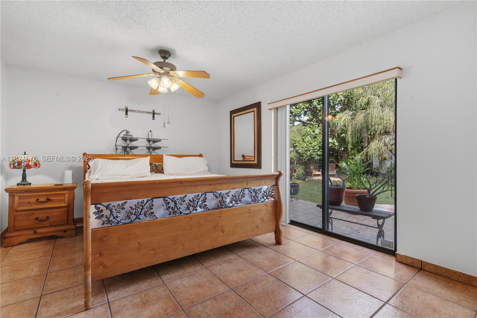 13585 Southwest 114th Terrace Miami, FL 33186 - Photo 19 of 42 a bedroom with a bed and a chandelier