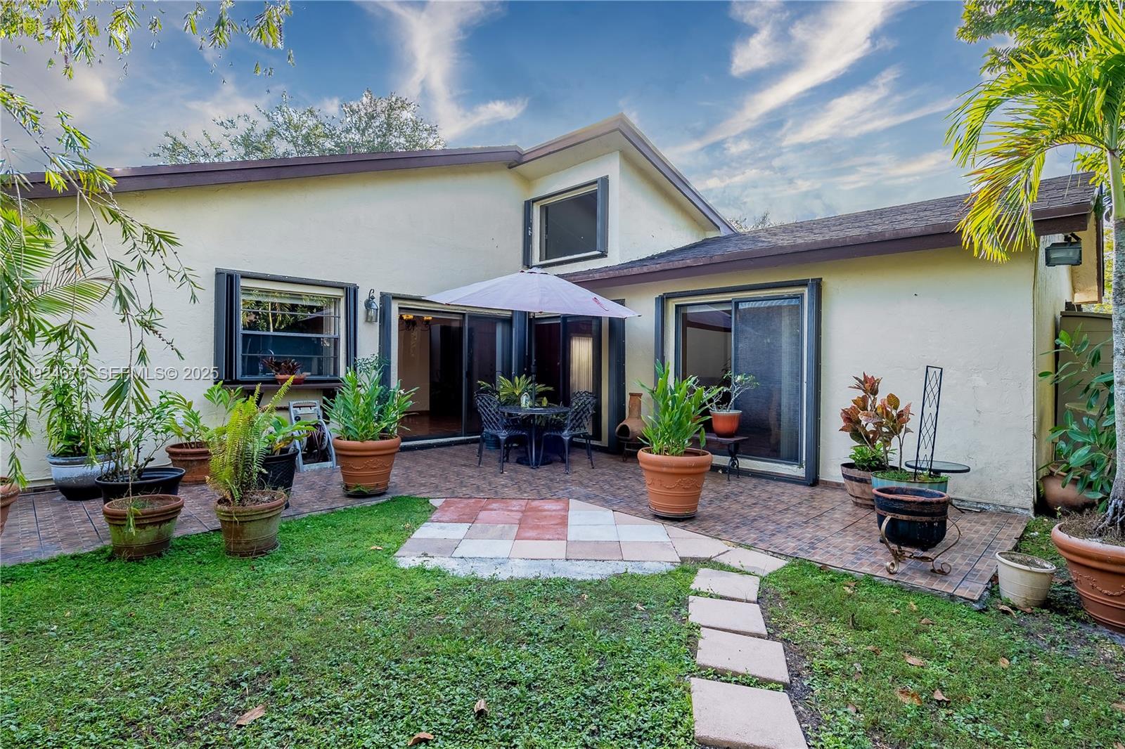 13585 Southwest 114th Terrace Miami, FL 33186 - Photo 32 of 42 a view of a house with backyard sitting area and garden