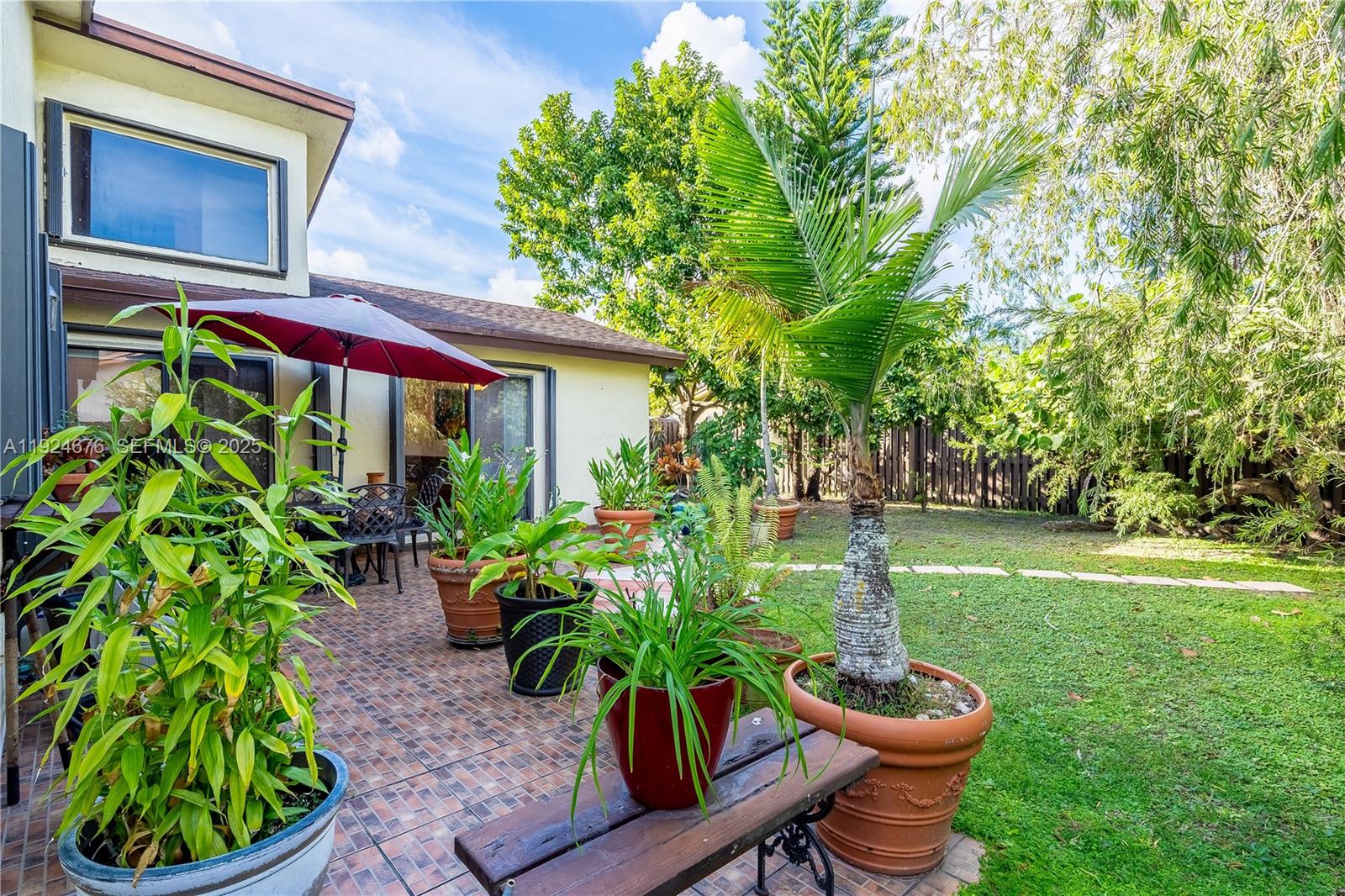 13585 Southwest 114th Terrace Miami, FL 33186 - Photo 33 of 42 a potted plant sitting in front of a house