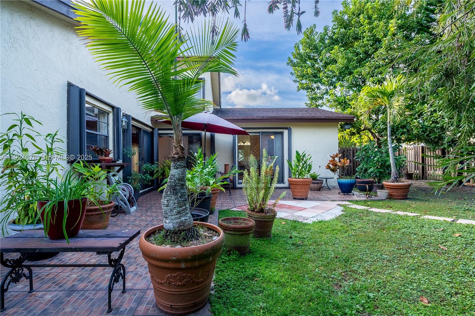 13585 Southwest 114th Terrace Miami, FL 33186 - Photo 38 of 42 a view of a chair and table in backyard of the house