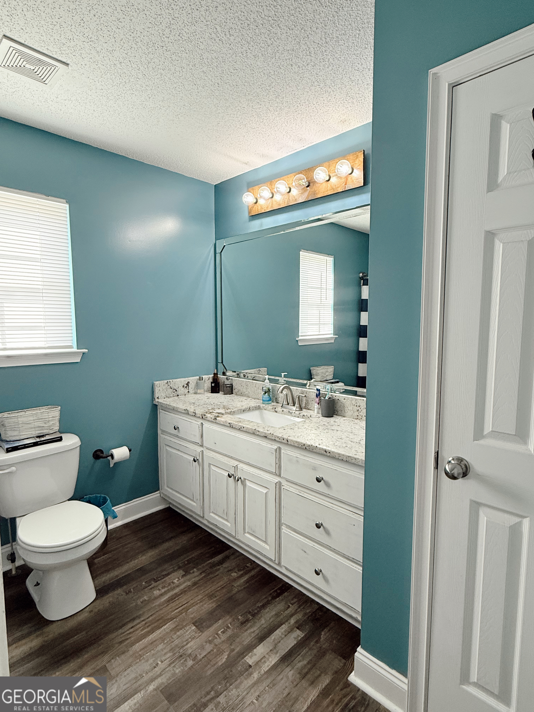 44 Quail Knoll Lane Cleveland, GA 30528 - Photo 17 of 42 a spacious bathroom with a toilet sink and mirror
