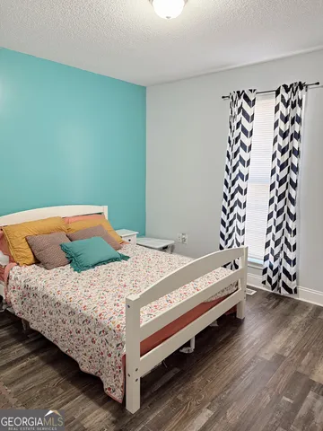 a bedroom with a bed and window