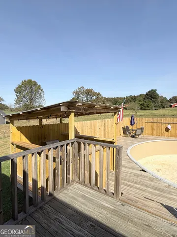 a view of a balcony with wooden floor and outdoor space