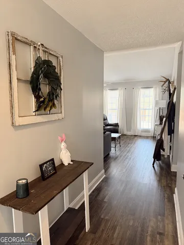 a view of a workspace with furniture and wooden floor