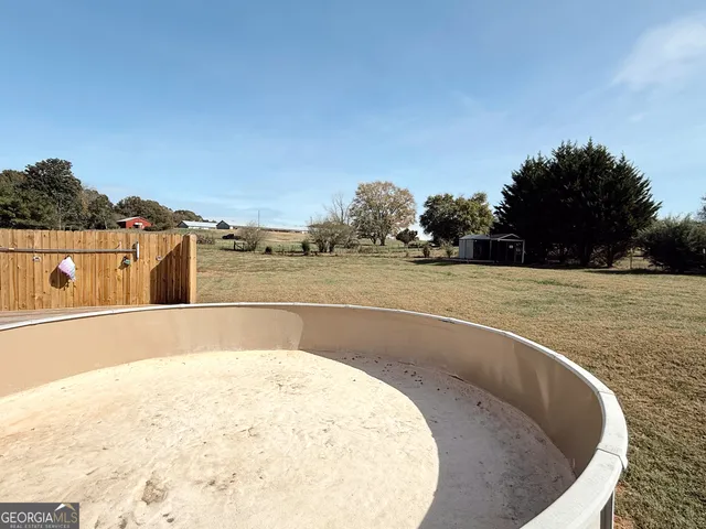 a view of a house with pool table and chairs