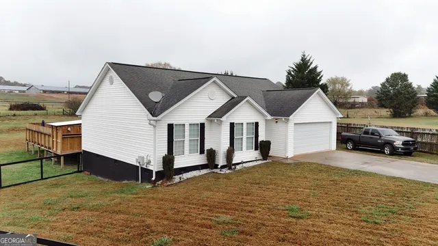 a view of a house with a yard and sitting area