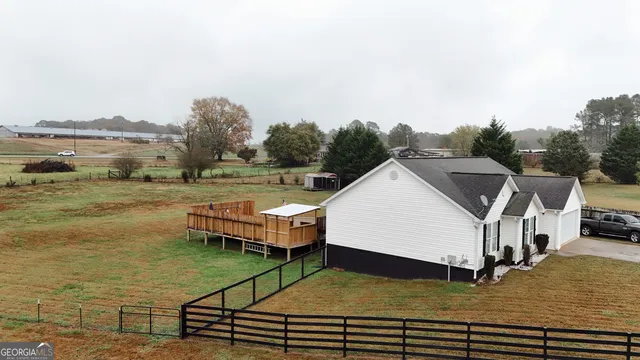 a view of a house with a yard and sitting area