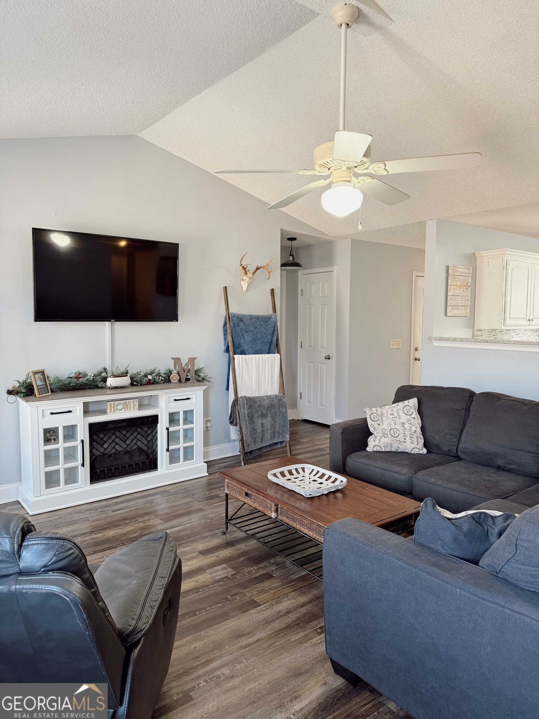 44 Quail Knoll Lane Cleveland, GA 30528 - Photo 6 of 42 a living room with furniture a fireplace and a flat screen tv
