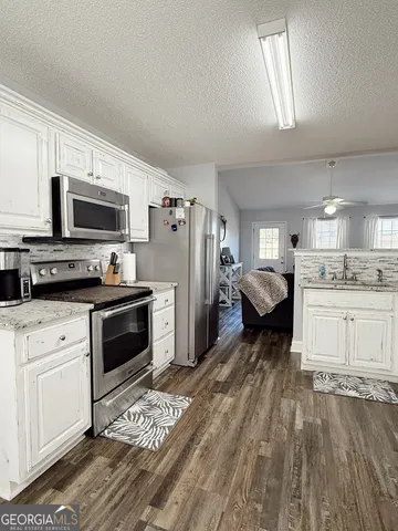 a kitchen with refrigerator and cabinets