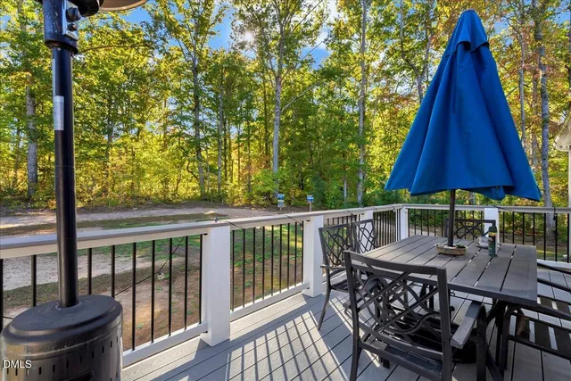 a view of balcony with wooden floor and fence