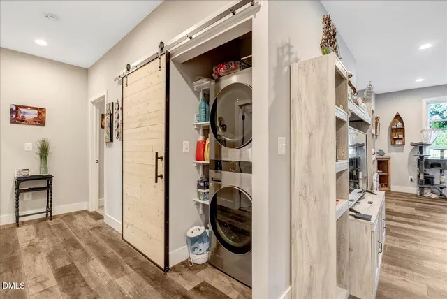 a kitchen with stainless steel appliances kitchen island granite countertop a stove a sink a refrigerator and white cabinets