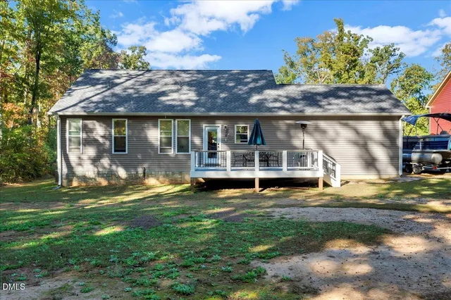 a view of house with a yard