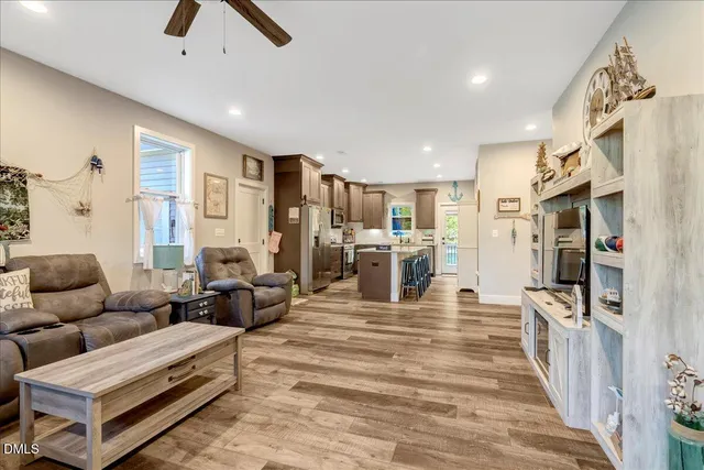 a living room with furniture and a wooden floor