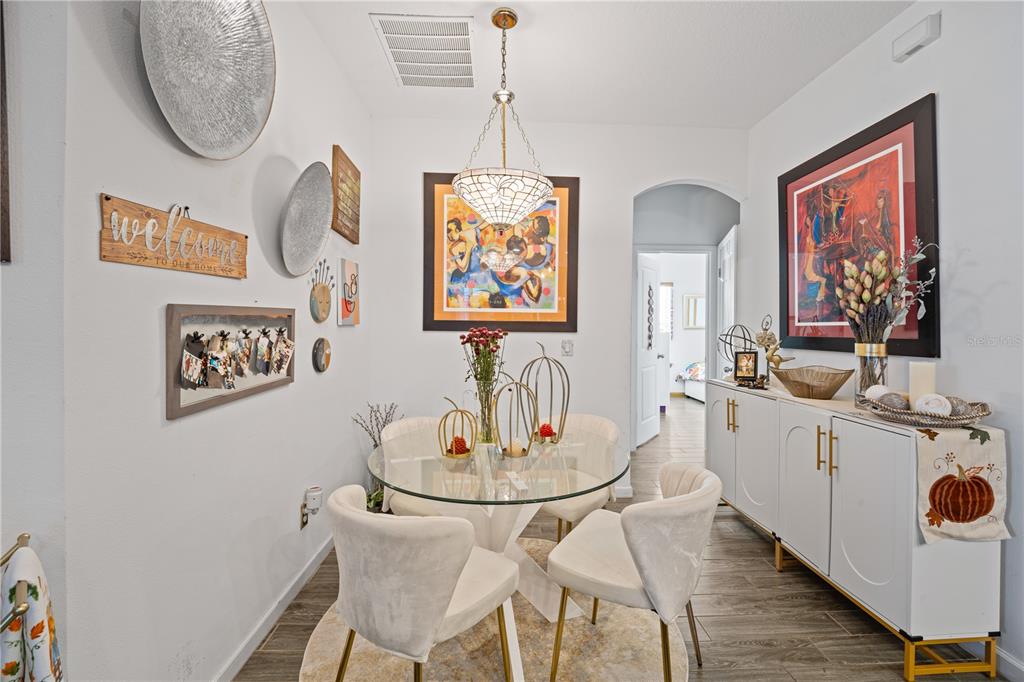 1722 Reflection Lane St. Cloud, FL 34771 - Photo 11 of 26 a view of a dining room with furniture wooden floor and a chandelier